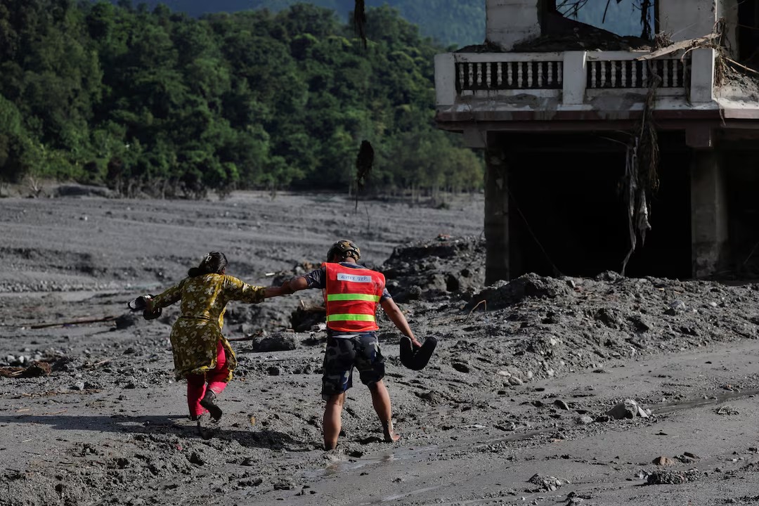 Lake overflows on Nepal-China border, sparking panic and halting rescue
